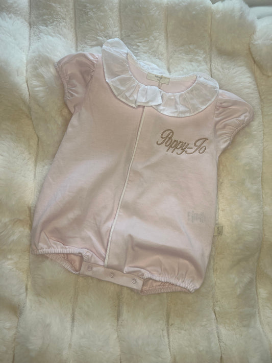 Pink frill angel wings romper.