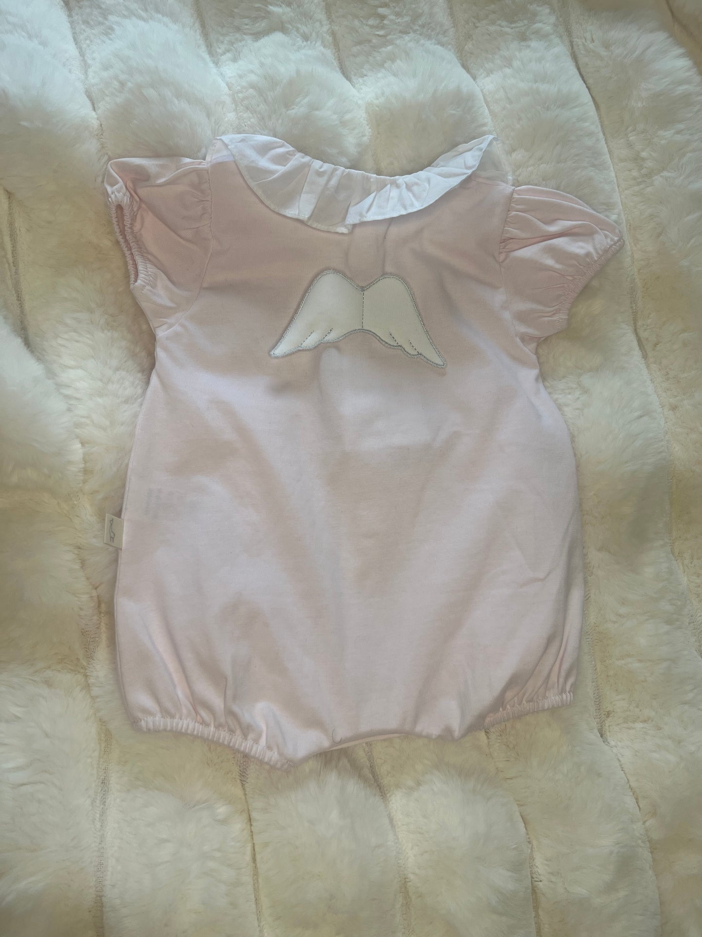 Pink frill angel wings romper.