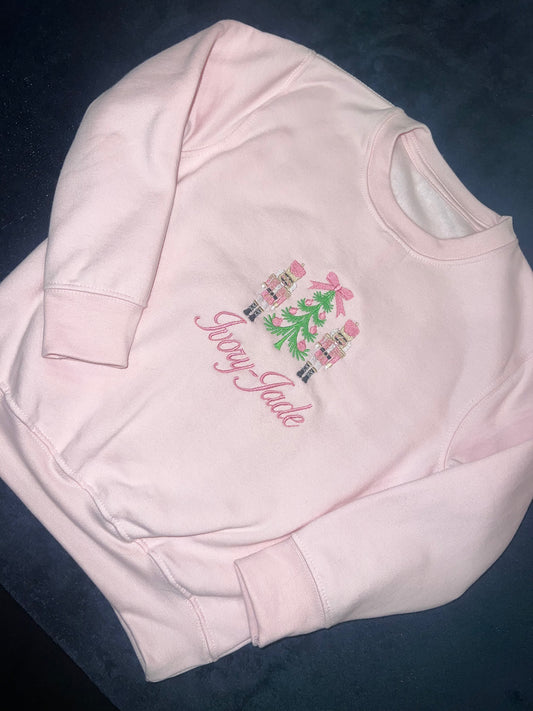 Girls pink nutcracker jumper with personalised name.